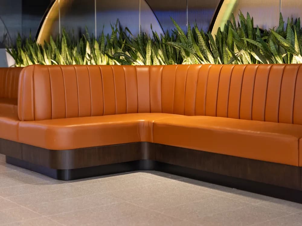Upholstered custom banquette seating in a refined interior