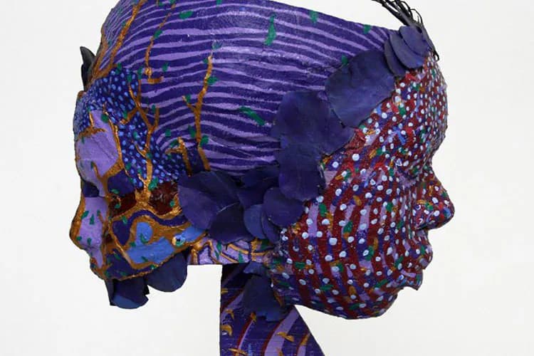 Mixed-media portrait of two overlapping heads in profile, rendered in deep purple, blue, orange, and red with geometric patterns and textured surfaces.