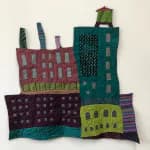 Fabric sculpture of colorful city buildings in textile