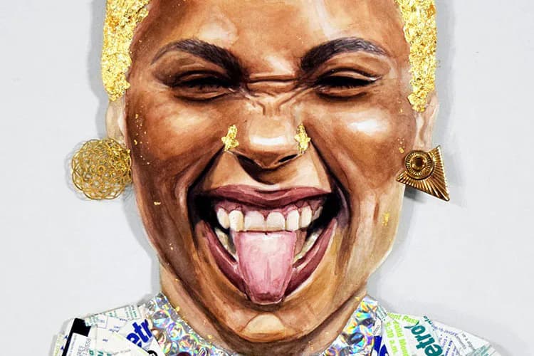 Mixed-media sculpture of a grinning face with gold leaf accents, tongue out, wearing colorful patterned shirt and gold circular earrings.