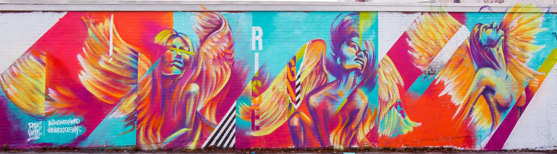 Colorful abstract mural with dynamic flowing figures in reds, oranges, blues, and yellows with geometric line work and striped patterns.