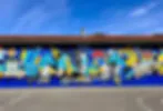 Blurry photograph of colorful graffiti or mural, details indistinct due to focus.