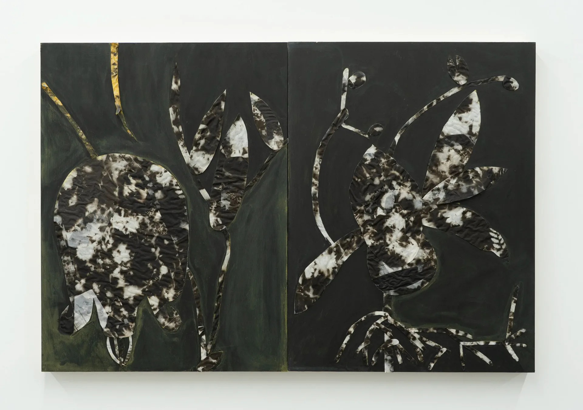 Large diptych with dark botanical silhouettes made from photographic material on dark green and black painted panels