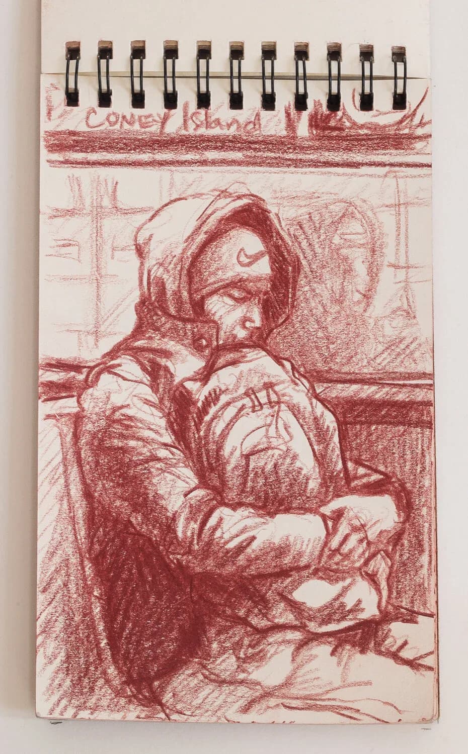 Red conte crayon sketch of a woman in a hooded coat cradling something on the subway, labeled Coney Island