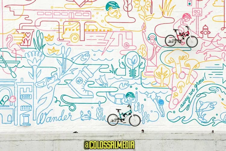 Woom Bikes colorful line-art mural with bikes in foreground