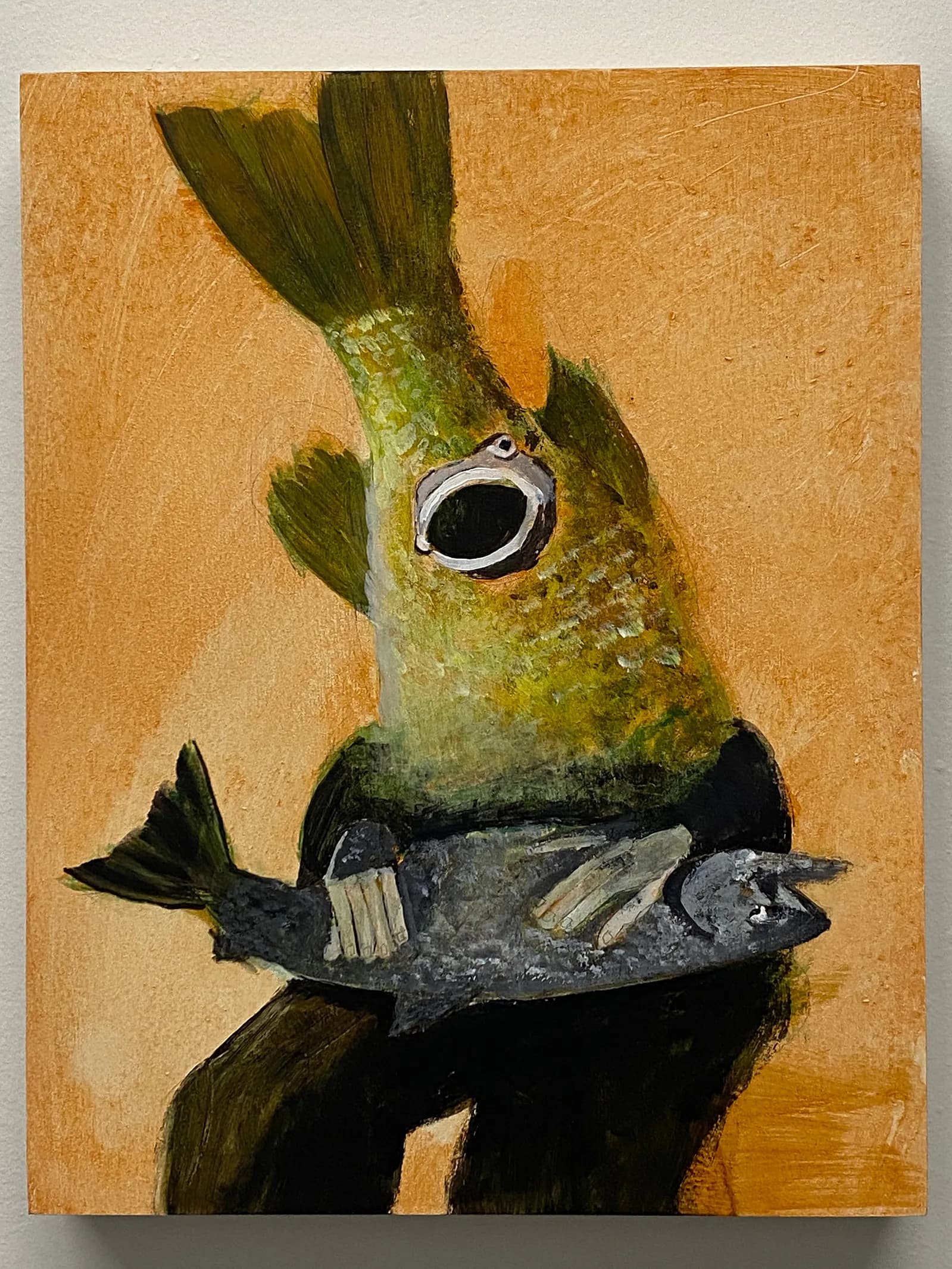 Mixed-media painting of a creature with a large circular eye and fish body against a golden-brown background.