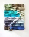 Large-scale textile wall piece with gradient blue-green to grey tones