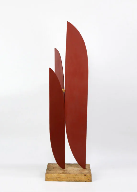 Welded Peaks painted steel and wood sculpture with tall dark red leaf-like forms on wooden base
