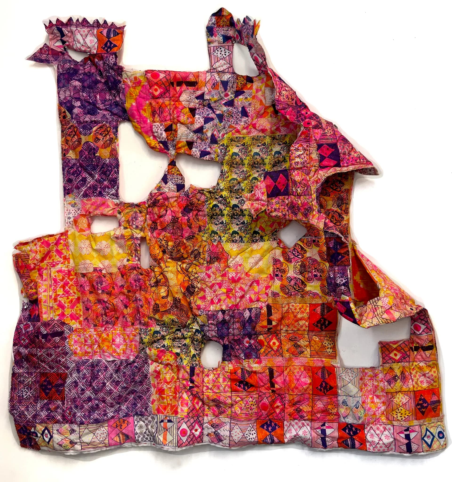 Colorful pink, orange and purple patchwork textile sculpture with architectural cutout form