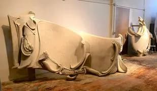 Large-scale wall sculpture installation in gallery, organic flowing forms