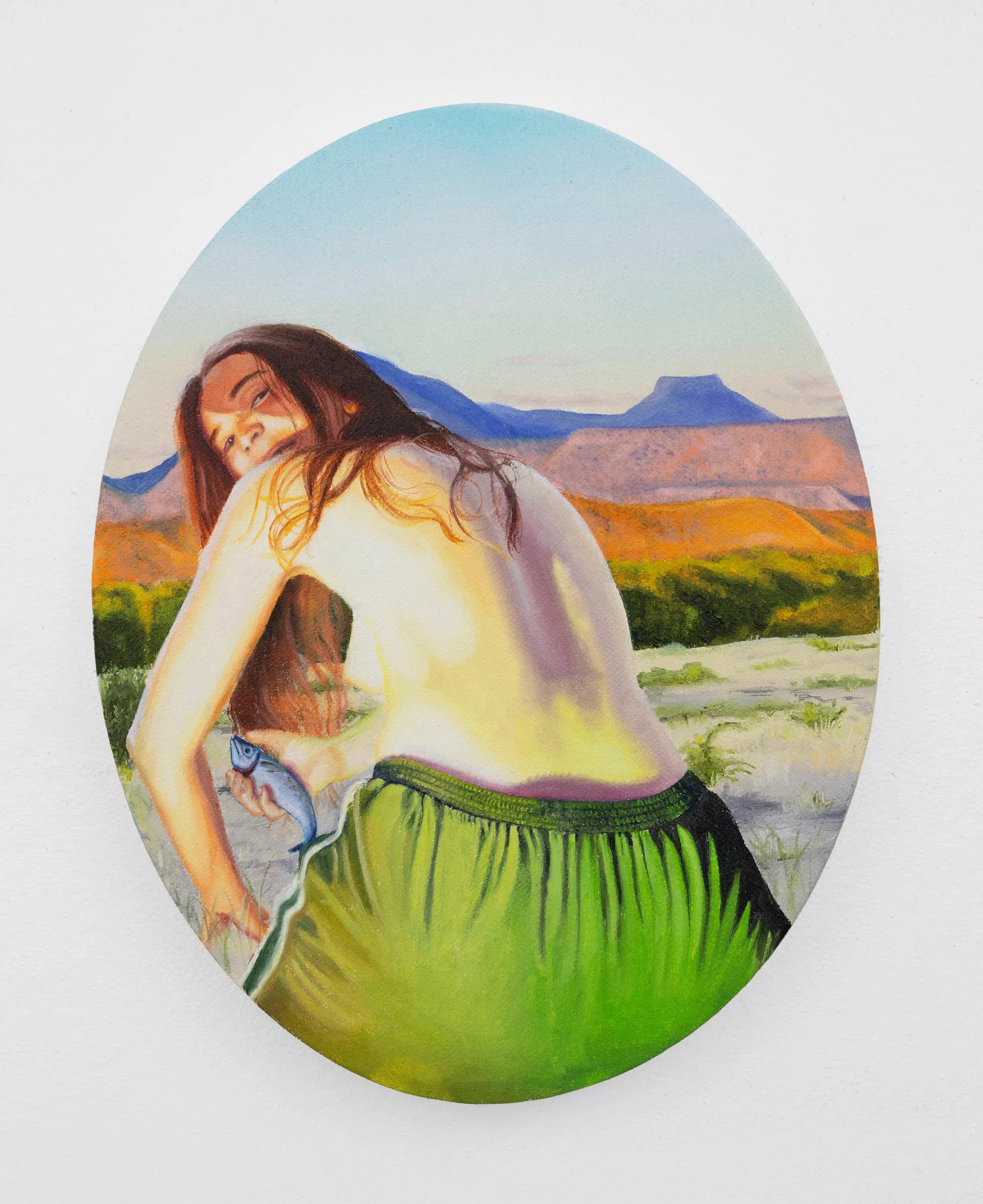 Woman holding a large open-mouthed fish above her face against an orange background with shadowy silhouette