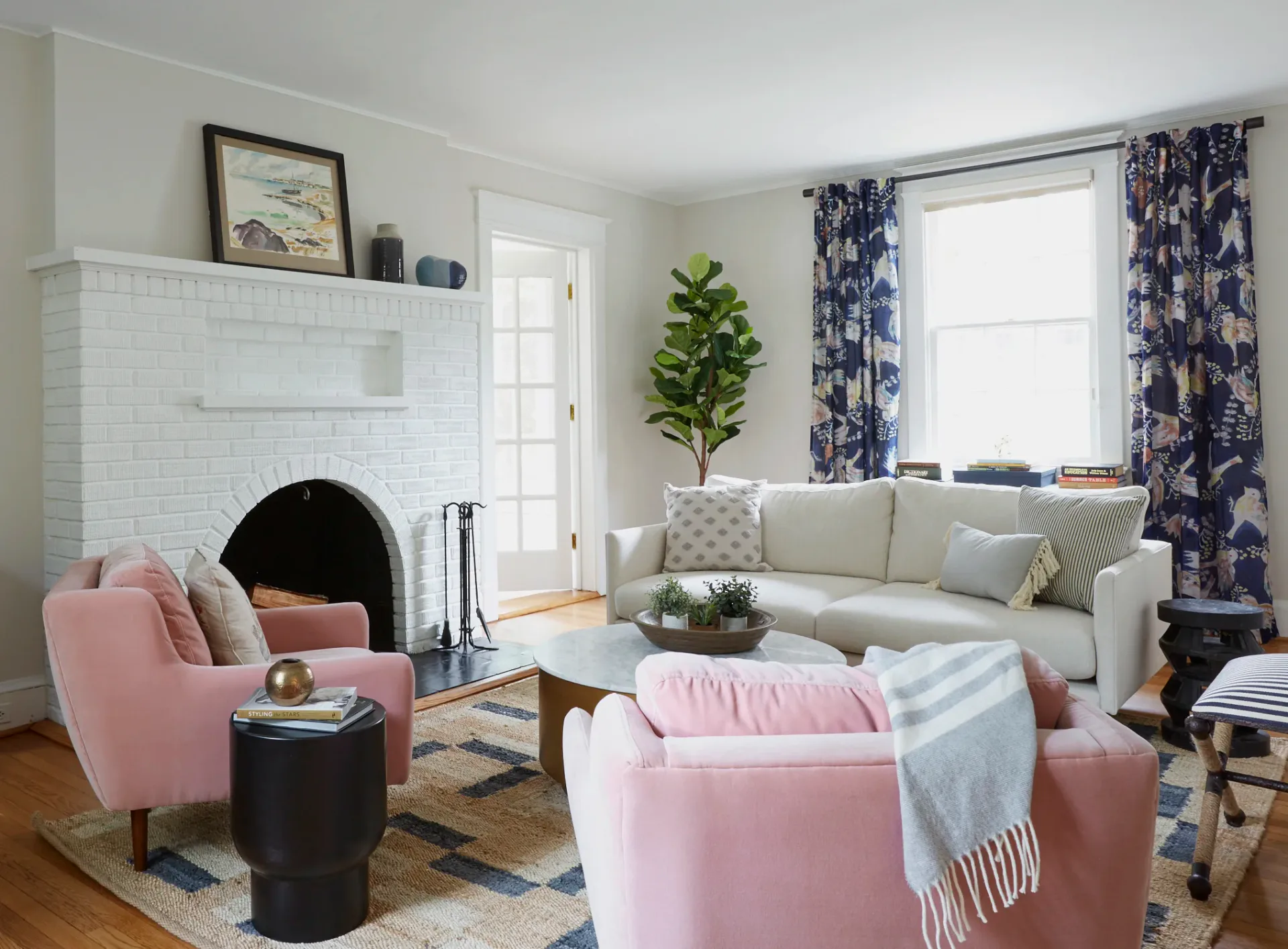 Elegant hallway with open French doors leading into a refined dining room with abstract red artwork