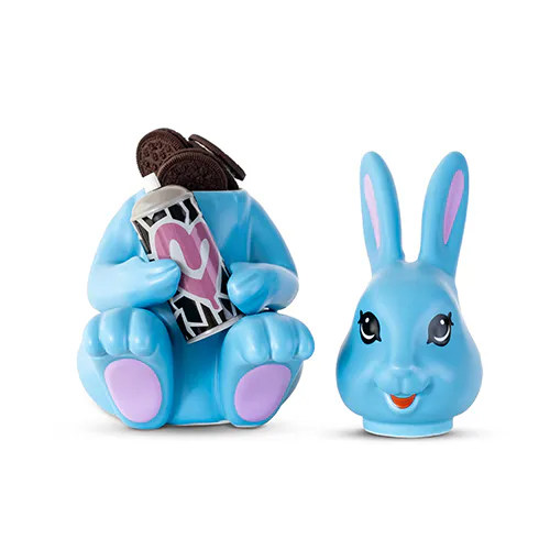 Two blue plush toy characters: a sitting figure with pink accents holding patterned fabric, and a smiling rabbit head.