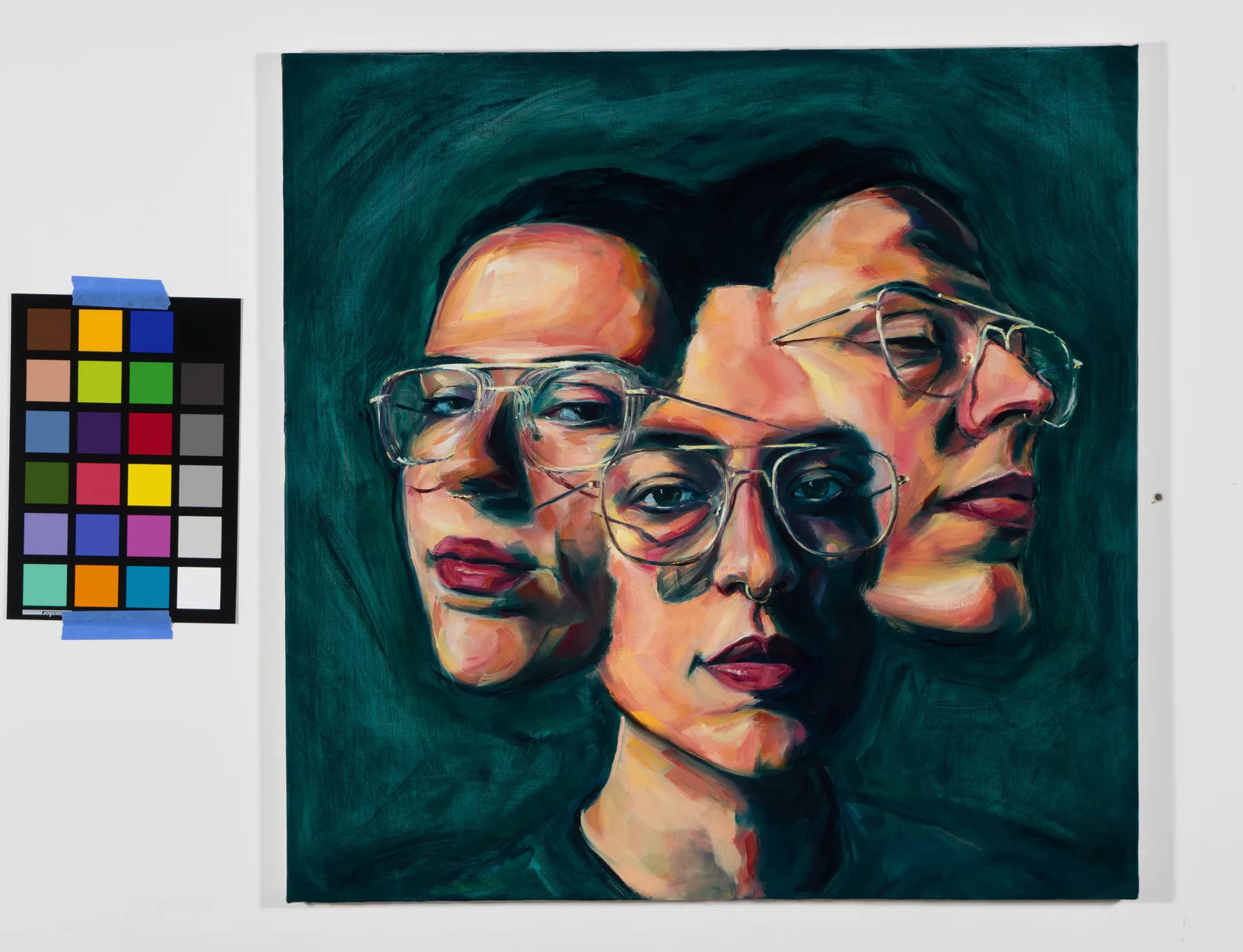 Oil painting of figure in denim seated with multiple overlapping faces against orange-red abstract background