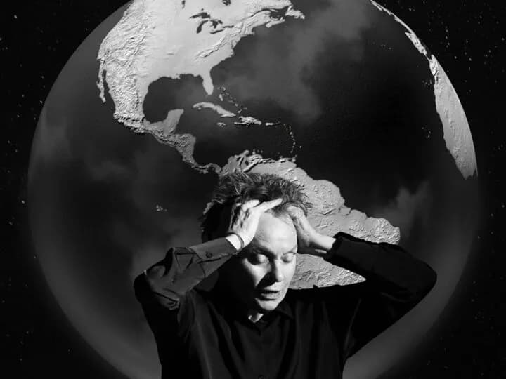 Black-and-white composite artwork featuring a man's portrait with hands behind head superimposed over a globe of Earth and starfield.