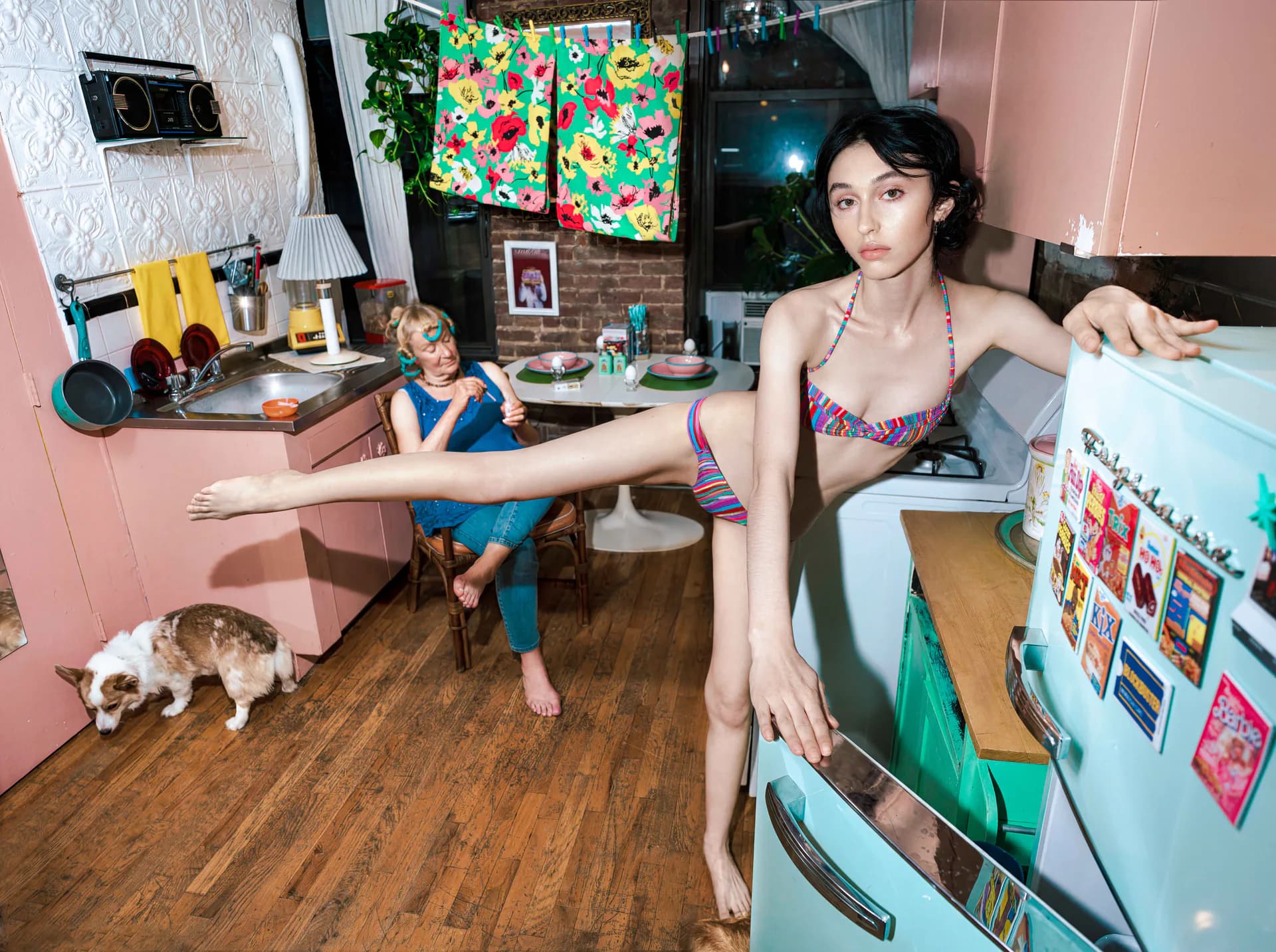 Man in suit standing on motel bed with briefcase — cinematic interior photograph