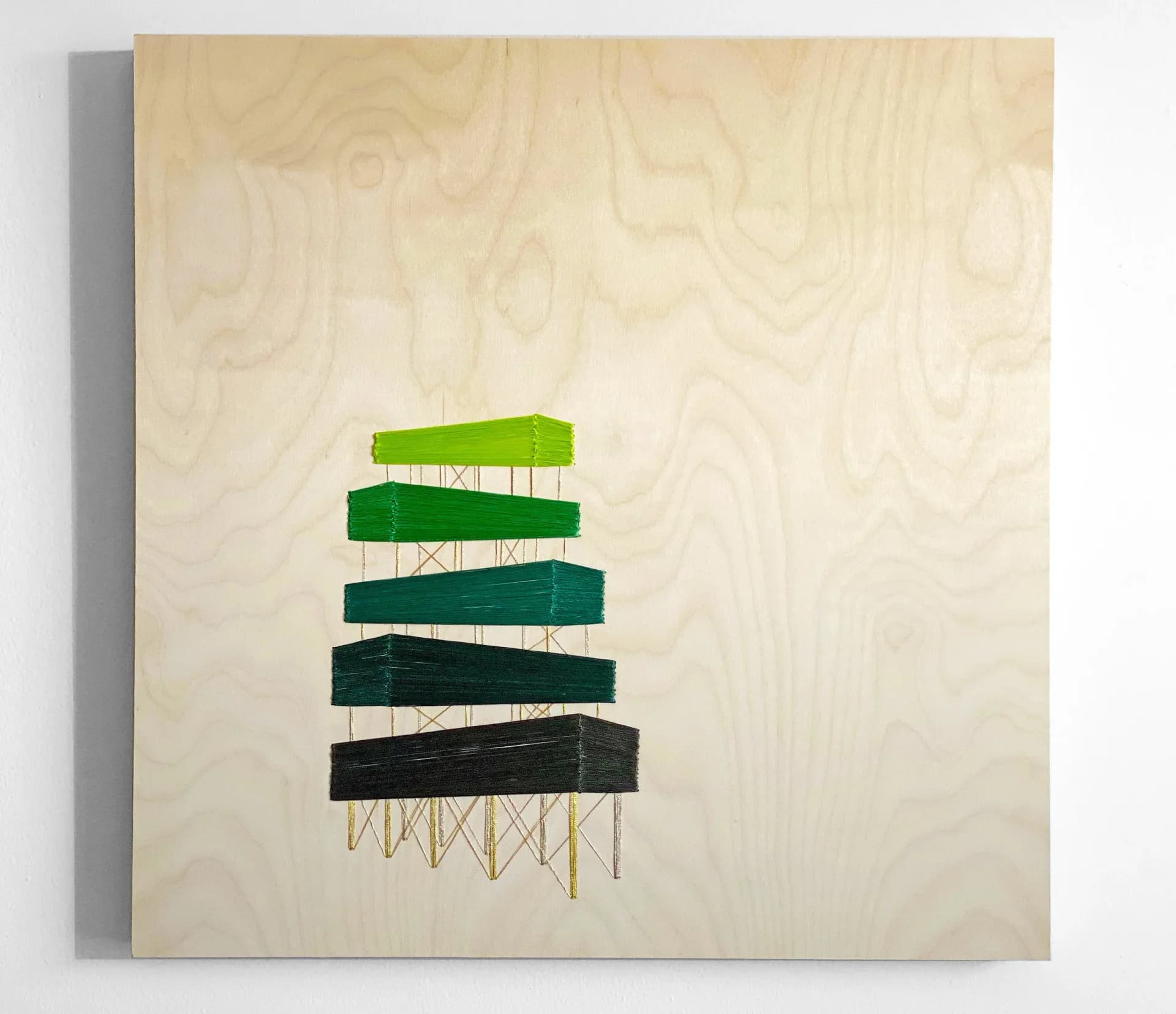 Abstract textile art on beige canvas showing stacked horizontal bands in green and black tones with geometric line patterns below.