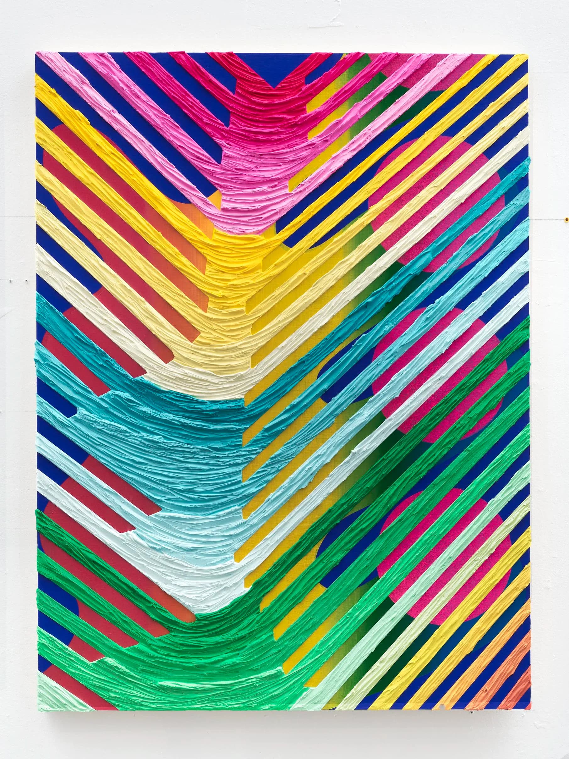 Large-scale abstract painting with colorful chevron/herringbone pattern of raised textured stripes in pink, yellow, teal and green on blue ground