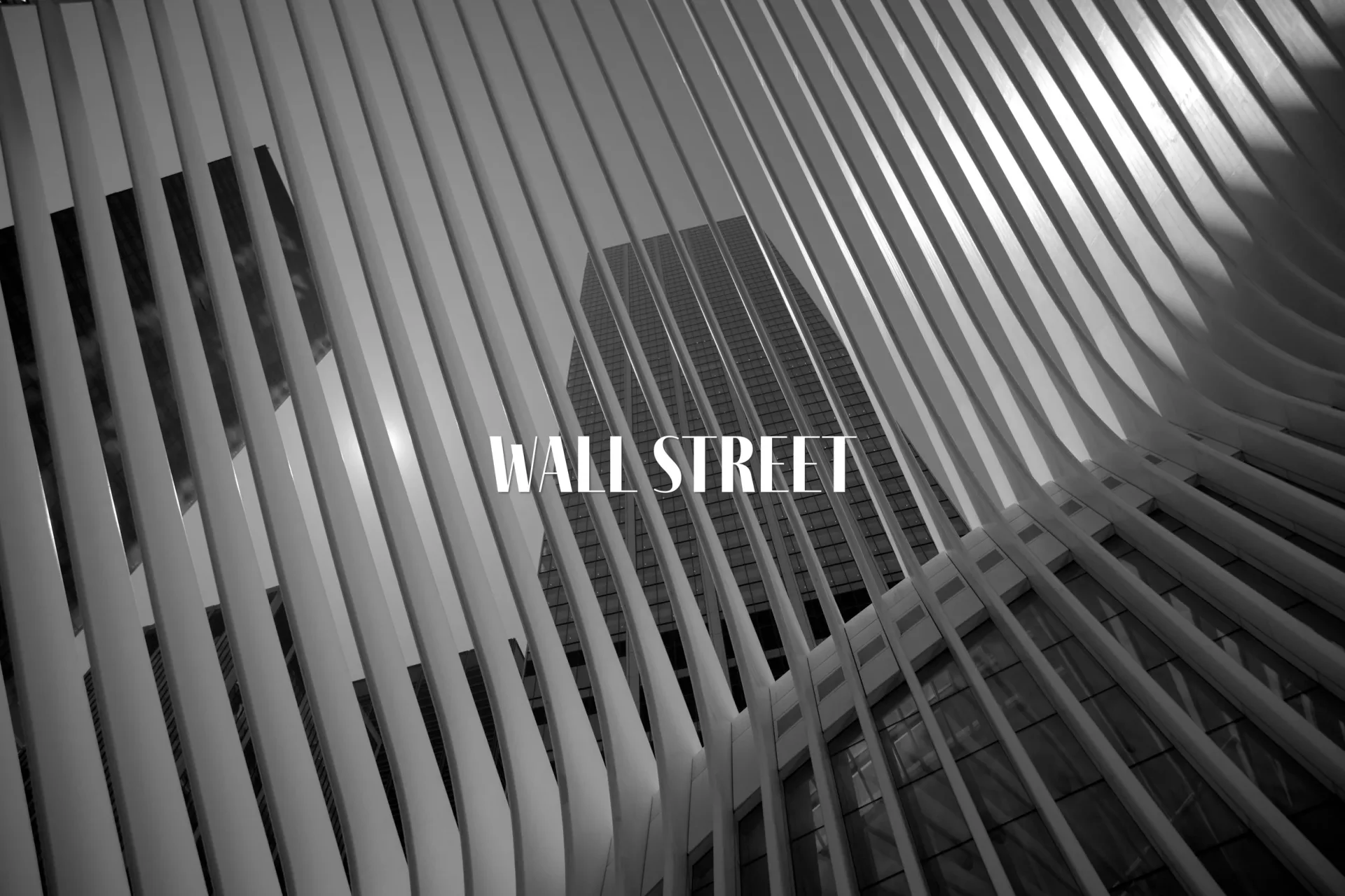 Black and white architectural photograph of repeating vertical ribbed structure with dramatic shadows; 'WALL STREET' text overlay.