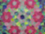 Colorful abstract textile or pattern with geometric shapes in magenta, lime green, navy, and yellow on repeating grid.