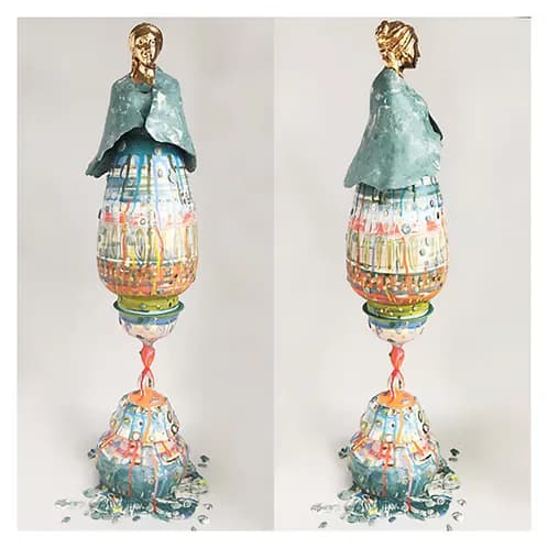 Tall ceramic figurative sculpture with gilded bust, painted vessel body, and colorful surface decoration