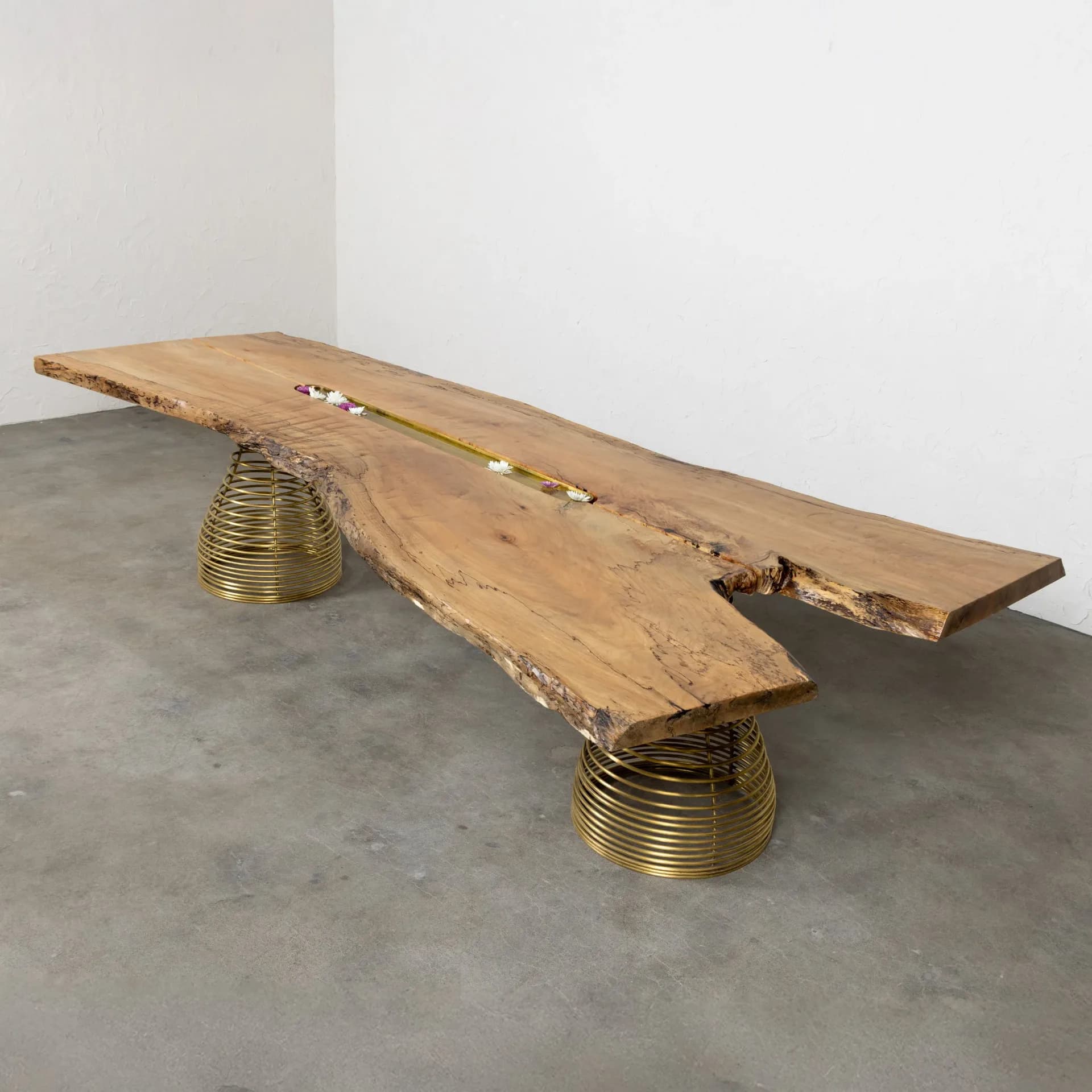 Full view of the Rivulet Table with live-edge spalted maple top and two brass coil spring bases