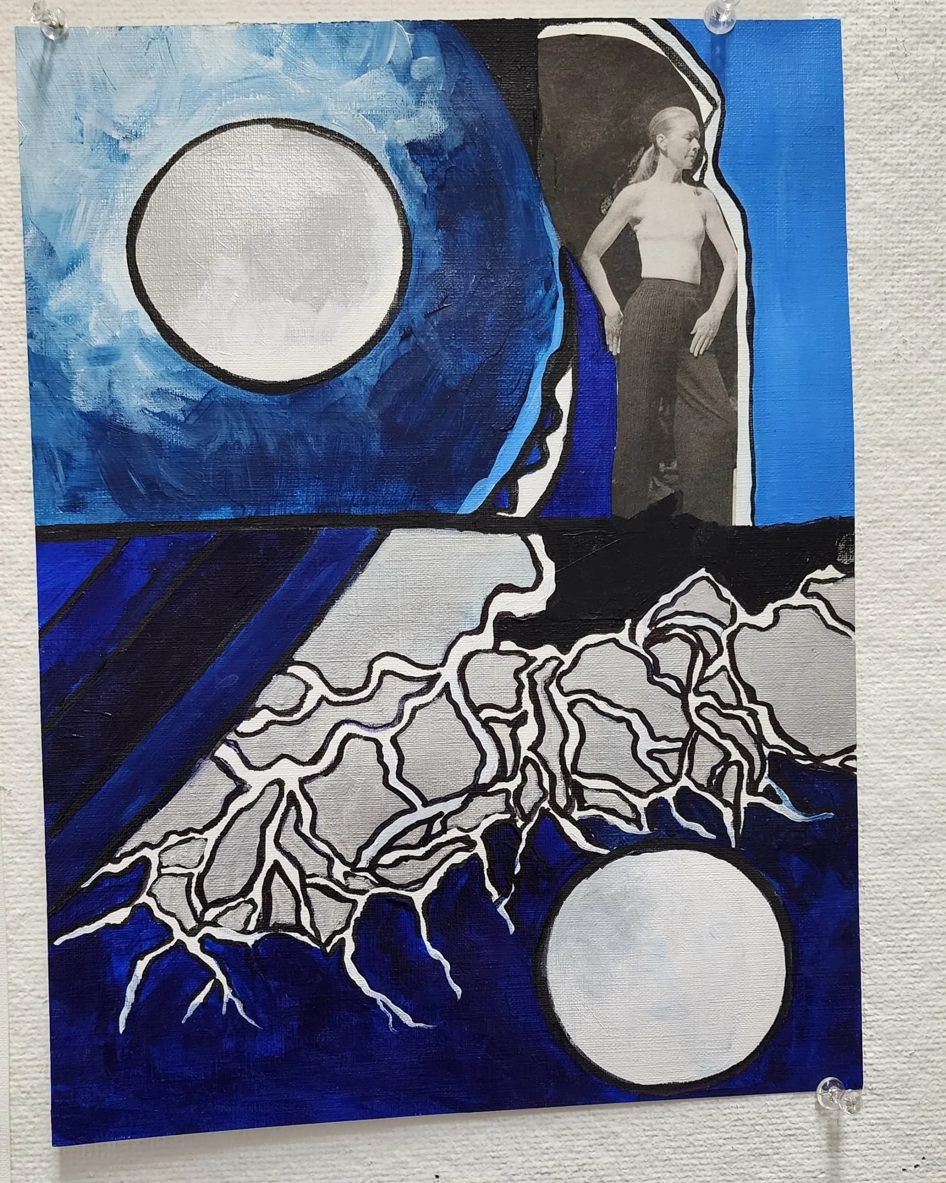 Mixed media painting combining acrylic and collage with moon forms, roots, and a figure in blue tones