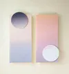 Two tall gradient panels with circular mirror element in lavender and pink