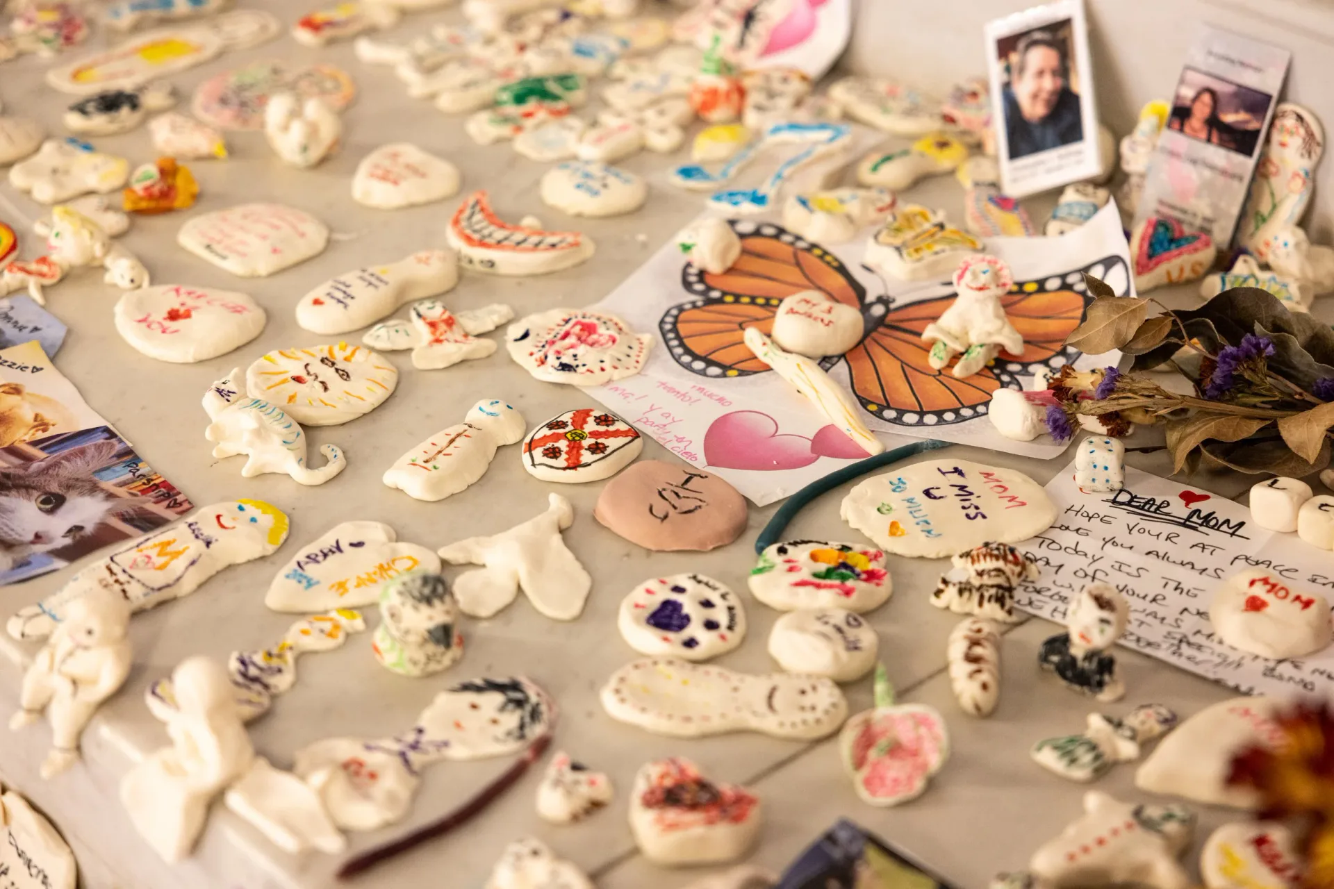 Large-scale purple painted installation inside a cathedral with stained glass windows, featuring a tipi-like structure with figurative murals and a central sculptural element on a grain mandala