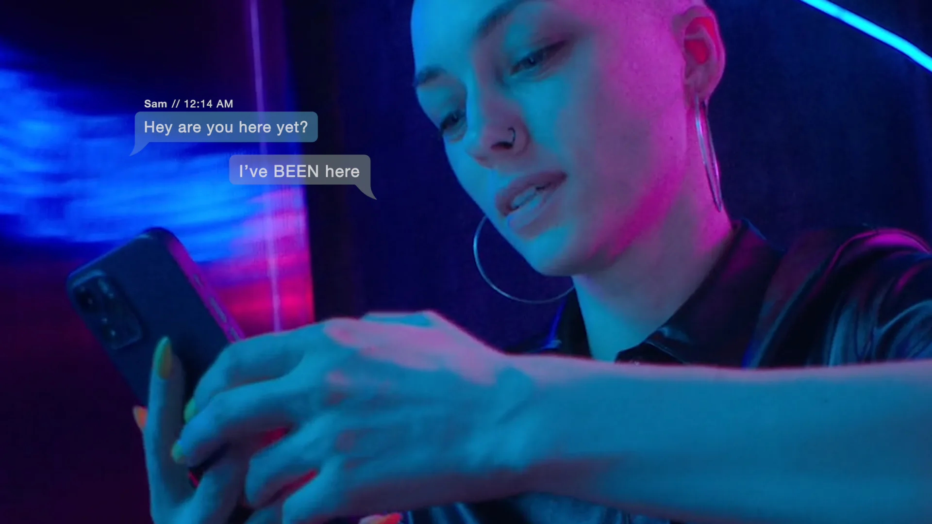 Woman under neon blue and pink light texting with speech bubble overlay
