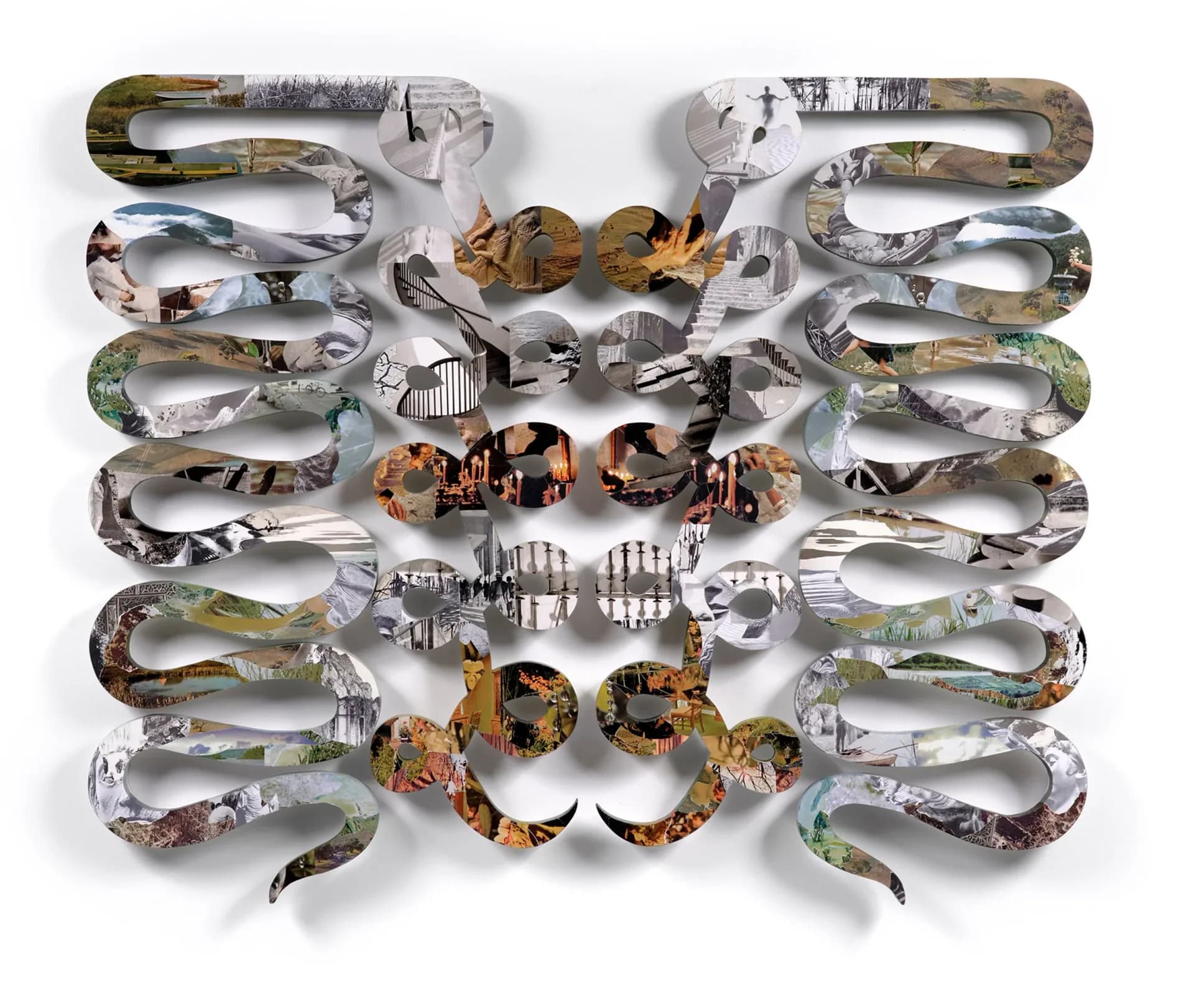 Large wall sculpture of interlocking S-shaped chain links in grey-silver photographic collage arranged in a symmetrical butterfly or mask-like pattern