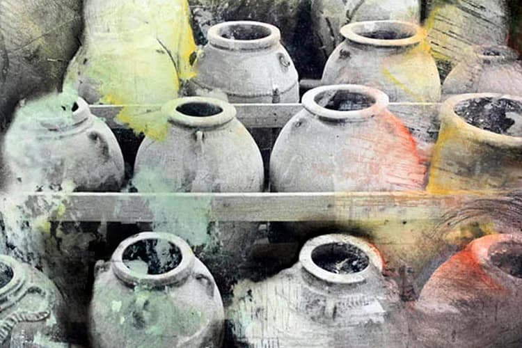 Multiple weathered ceramic vessels with rounded bodies and narrow openings, arranged on shelves, showing patina and discoloration in earth tones.