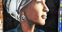 Detailed portrait mural of a woman in profile with head wrap and earrings