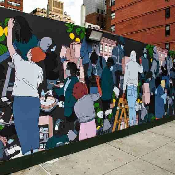 Large mural depicting a diverse crowd of figures in muted tones of blue, pink, and gray engaged in community gathering or market scene.
