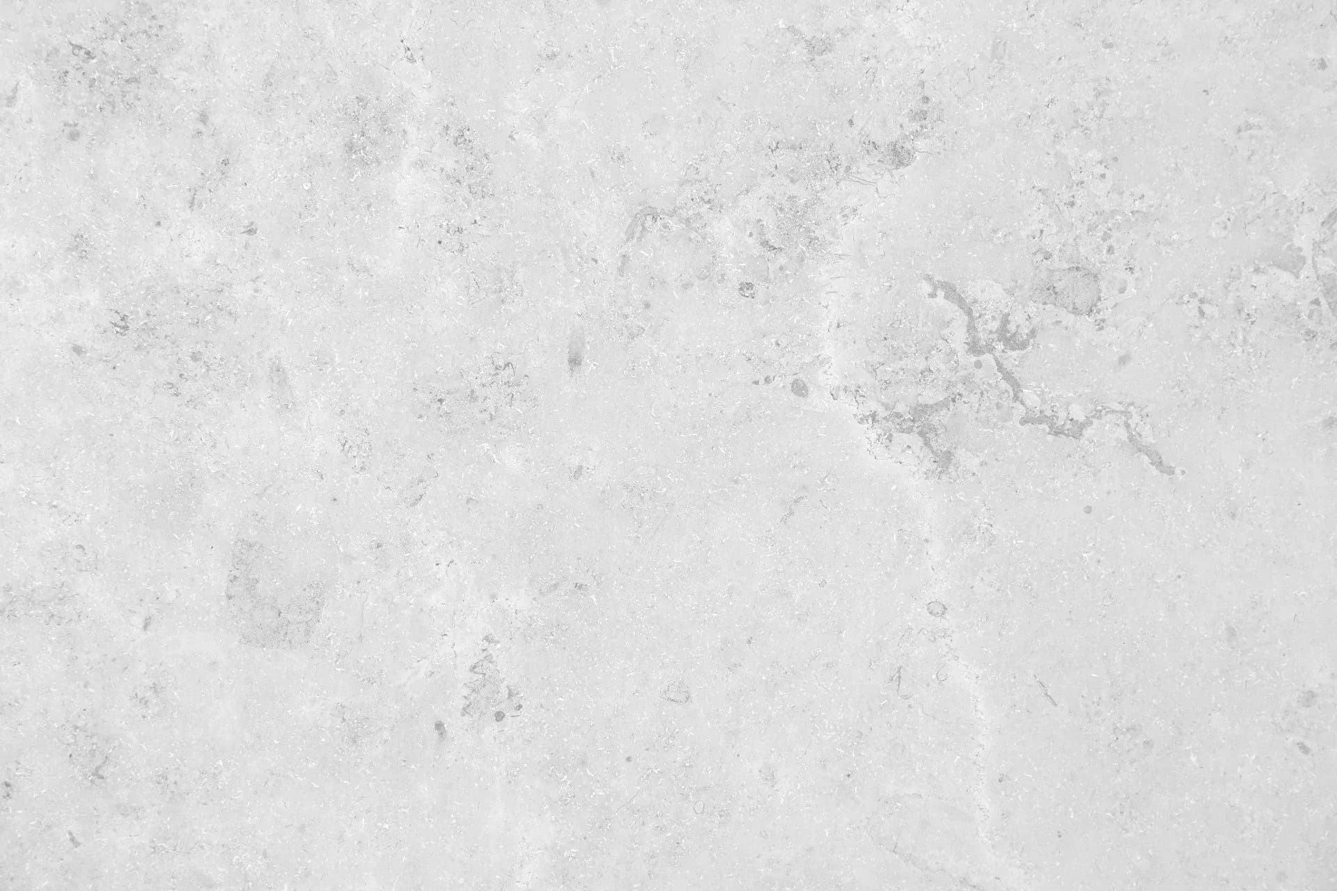 Textured white and gray abstract surface with organic stains and weathered markings, minimal composition.