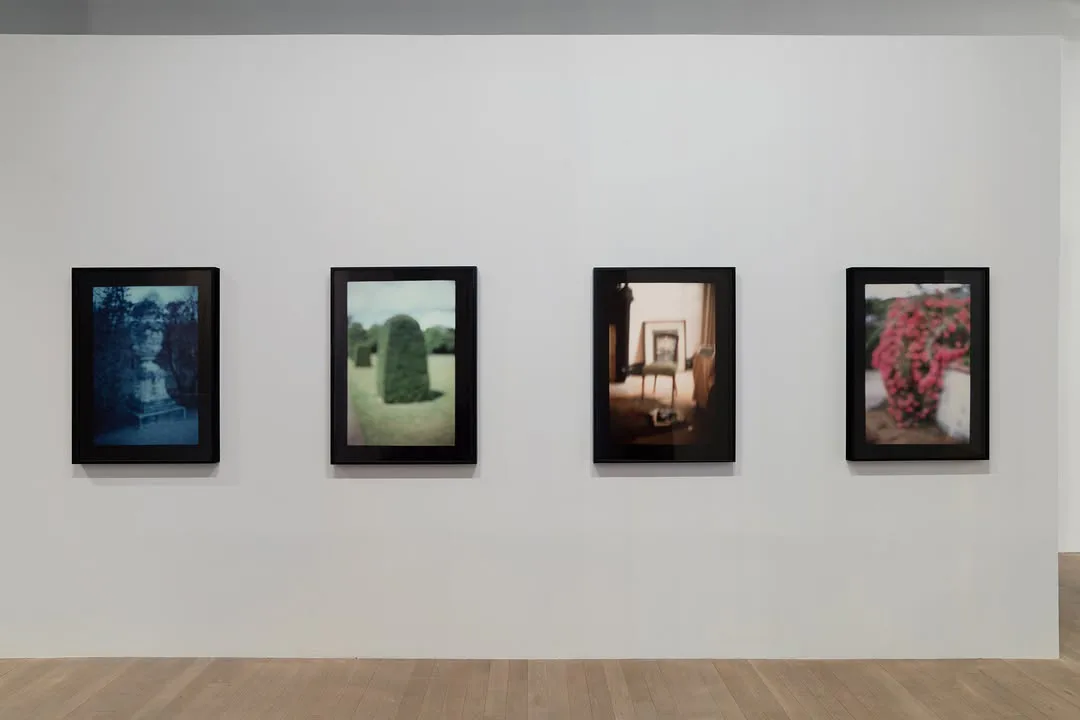 Gallery interior at Artists Space showing four framed photographs mounted on white wall, neutral lighting on polished floor.