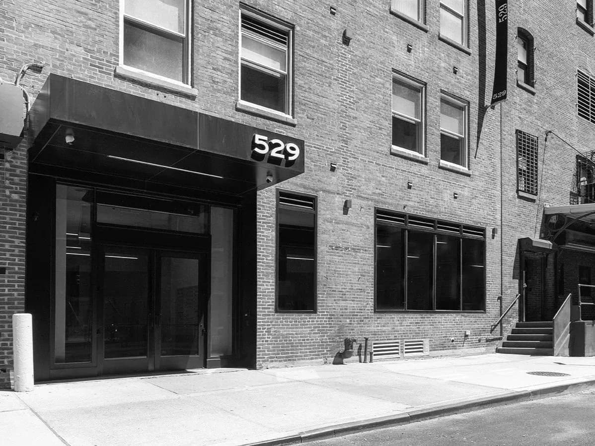 Storefront entrance of Benrubi Gallery at 529, brick facade with glass doors and awning