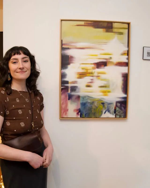 Abstract mixed-media painting with yellow, brown, and colorful brushstrokes in soft focus composition.