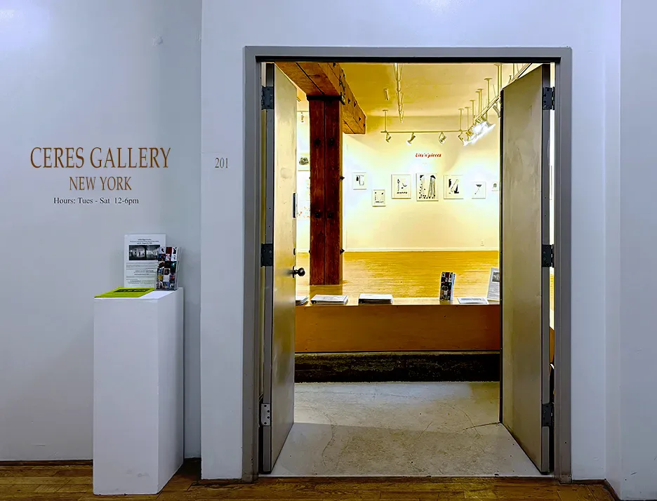 Entrance doorway of Ceres Gallery opening into a bright interior with wood beam, track lighting, and framed artworks on the walls