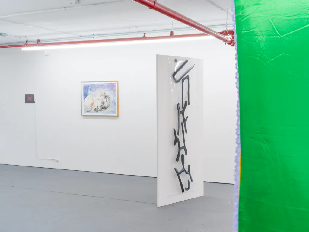 D. D. D. D. gallery corner showing white and green wall partitions, framed blue-toned artwork, vertical black ink drawing, red ceiling pipes, and bright green accent wall.