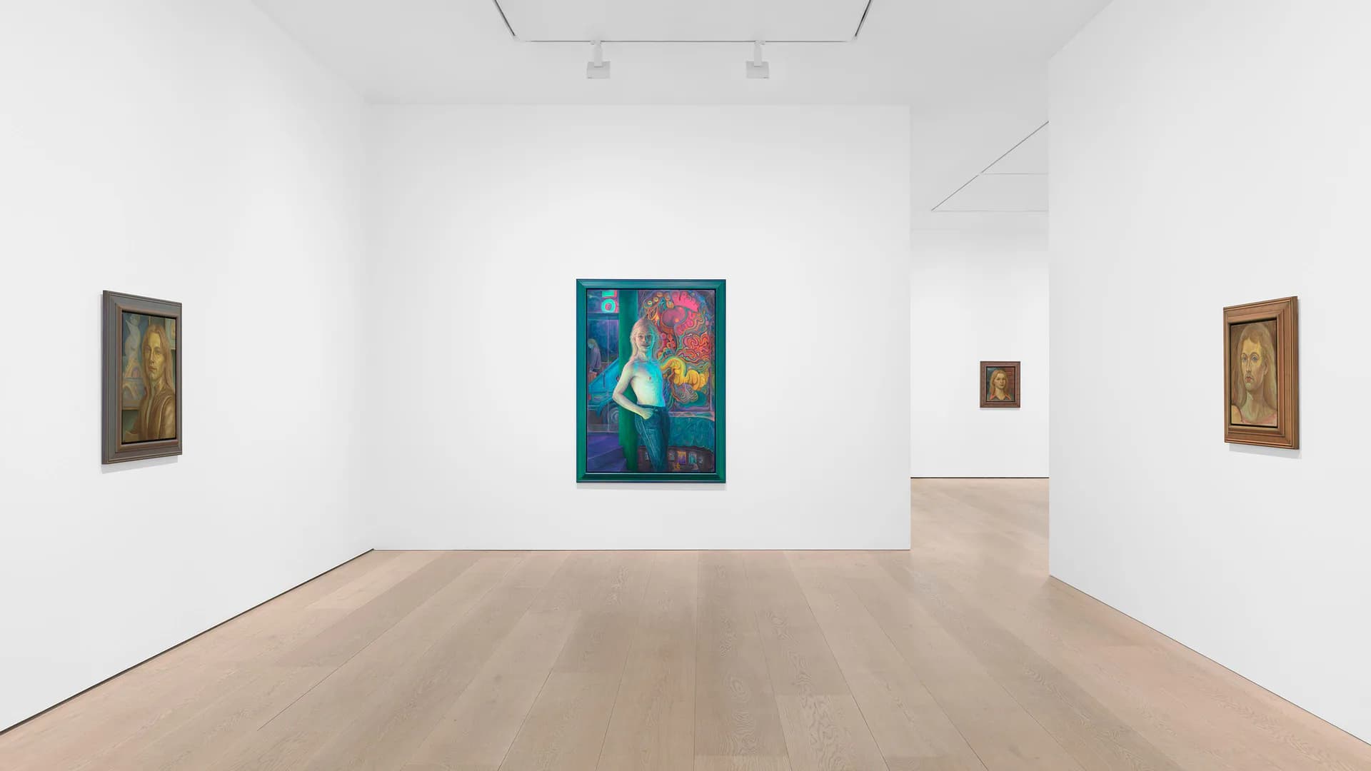 Gallery interior with light wood flooring, white walls, and recessed lighting. A colorful teal and pink portrait painting centered on back wall, flanked by smaller figurative paintings in gold and brown tones.