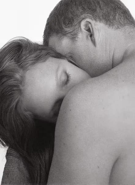 Black and white portrait drawing of two people in an intimate embrace, rendered in graphite.