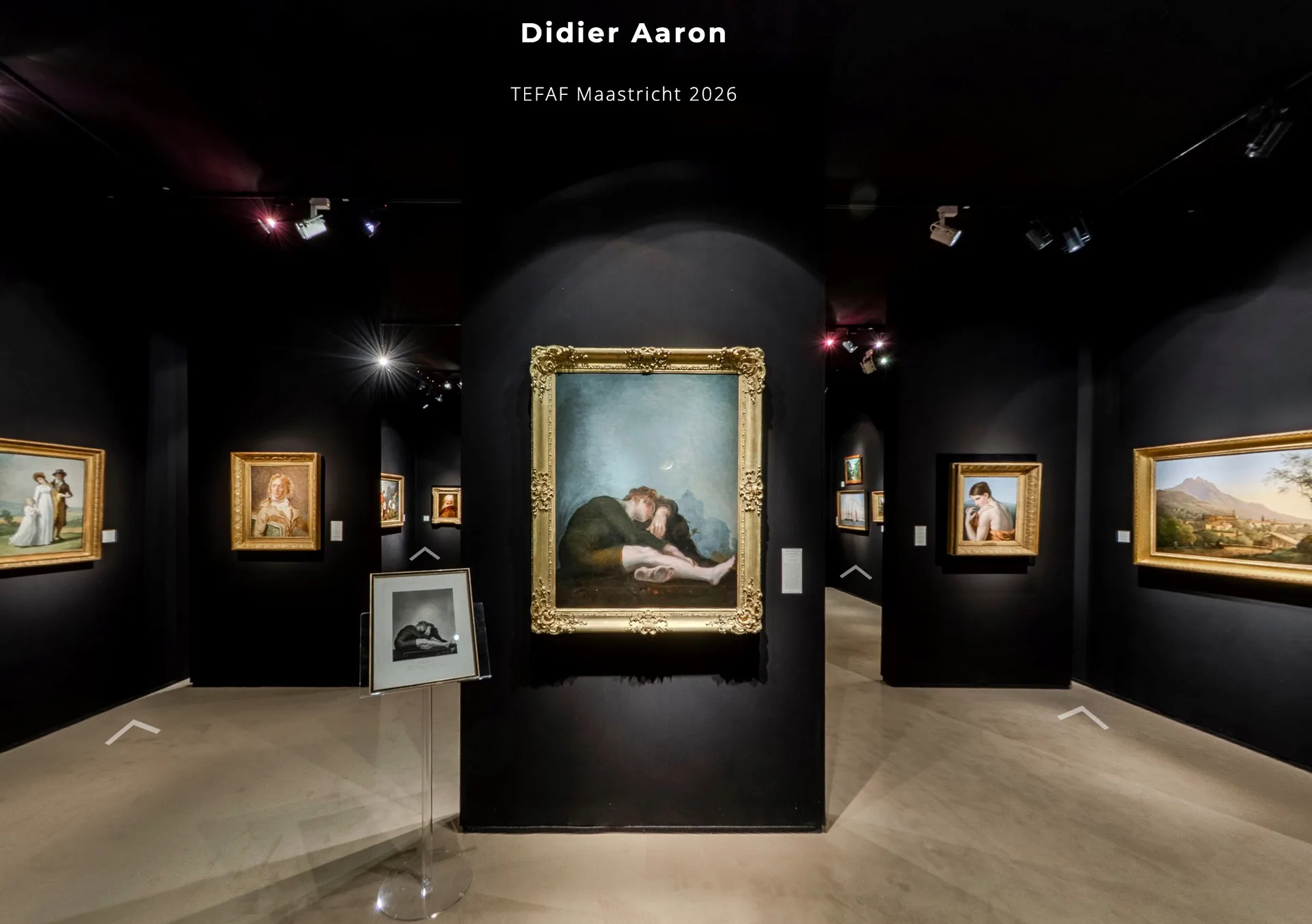 Dark gallery interior with gold-framed paintings on black walls under spotlight track lighting