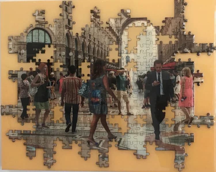 Partial jigsaw puzzle artwork showing a crowd of people in an ornate architectural setting against a tan background.