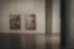 Galerie Ground interior with framed photographs displayed on concrete wall, gallery lighting.