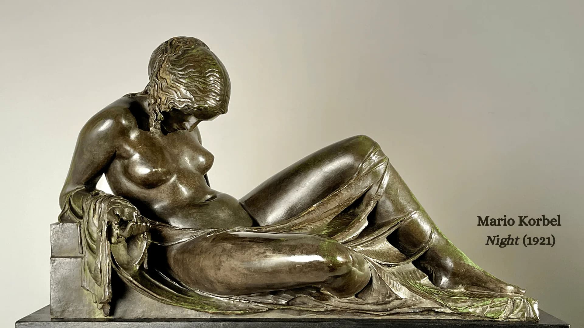 Bronze reclining female figure sculpture by Mario Korbel, titled Night (1921), showing classical draped form on a rectangular base.