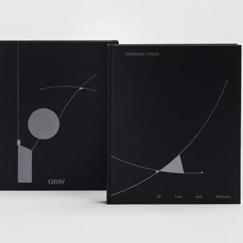 Two open book covers with minimalist geometric designs in grayscale and white lines on black backgrounds, labeled 'GRAY'.