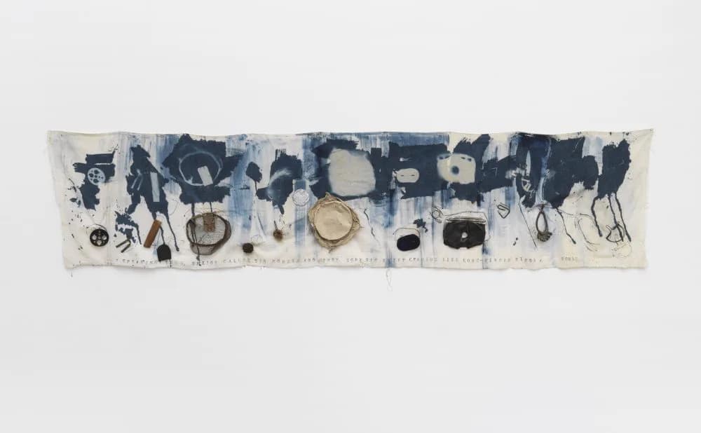 Horizontal textile artwork with indigo and cream tones featuring abstracted figures, circular forms, and organic shapes created through mixed media technique.