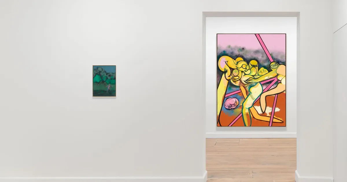 GRIMM gallery wall displaying a small teal abstract painting on the left and a framed colorful pop-art style illustration on the right above a wooden storage unit.