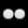 Pair of white or light gray spherical objects against a neutral background.